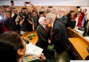 Judge Dennise Garcia, left front, watches as George Harris, center left, 82, and Jack Evans, center right, 85, kiss after being married by Judge Garcia Friday, June 26, 2015, in Dallas. Gay and lesbian Americans have the same right to marry as any other couples, the Supreme Court declared Friday in a historic ruling deciding one of the nation's most contentious and emotional legal questions. Celebrations and joyful weddings quickly followed in states where they had been forbidden. (AP Photo/Tony Gutierrez)